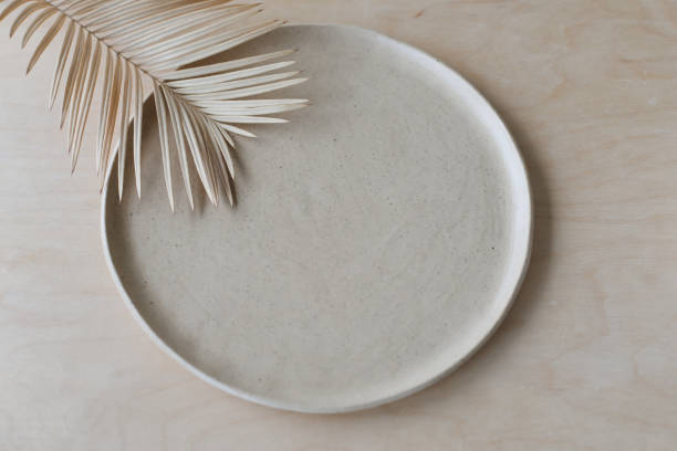keramikplatte auf einer holztischplatte ansicht. minimalistisches handgefertigtes keramikgeschirr und keramik - plate ceramics pottery isolated stock-fotos und bilder