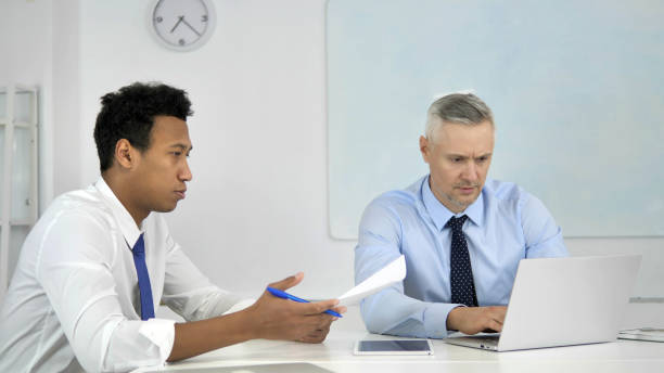 istock Multi Ethnic Businessmen Working Together on Business Project in Office 1340727524