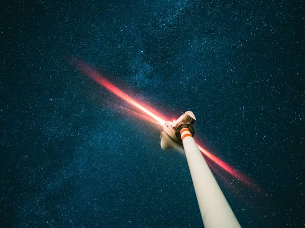 un aerogenerador bajo las estrellas por la noche - blurred motion abstract electricity power line fotografías e imágenes de stock