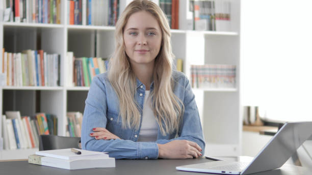 istock Smiling Young Blonde Woman Looking at Camera in Office 1340731820