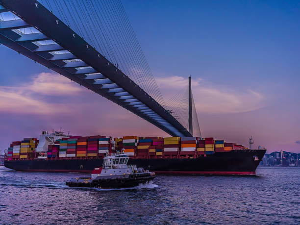 istock Big container ship crossing stonecutter bridge in the evening 1340731834