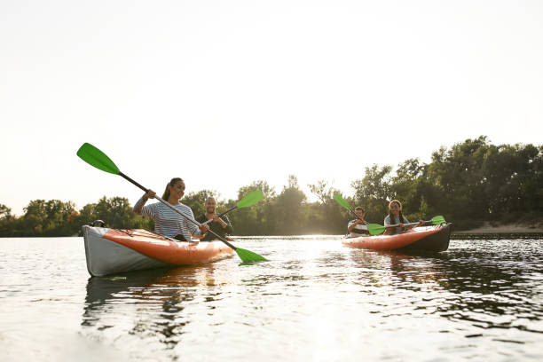 istock Joyful young people kayaking together on a river, spending weekend outdoors on a summer day 1340735770
