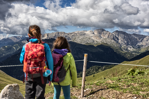 Family with children hiking on the Dolomites: outdoor adventures