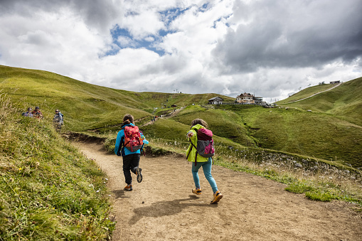 Family with children hiking on the Dolomites: outdoor adventures