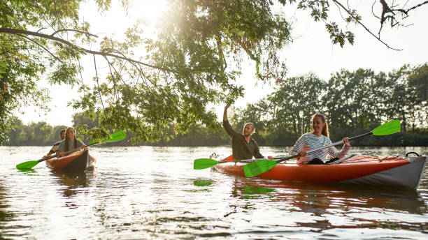 istock Active happy people having fun together while kayaking on the river on a sunny day during summer vacation 1340739655