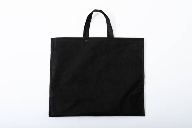 istock Composition of empty black canvas shopping bag lying flat on white background 1340739827