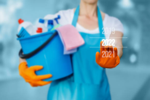 istock Cleaning lady on the virtual screen clicks on the new year 2022. 1340741236