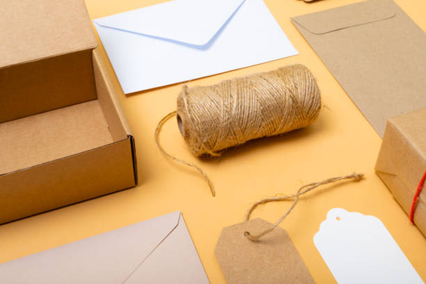 istock Composition of boxes, envelopes and gift tags on yellow background 1340742464