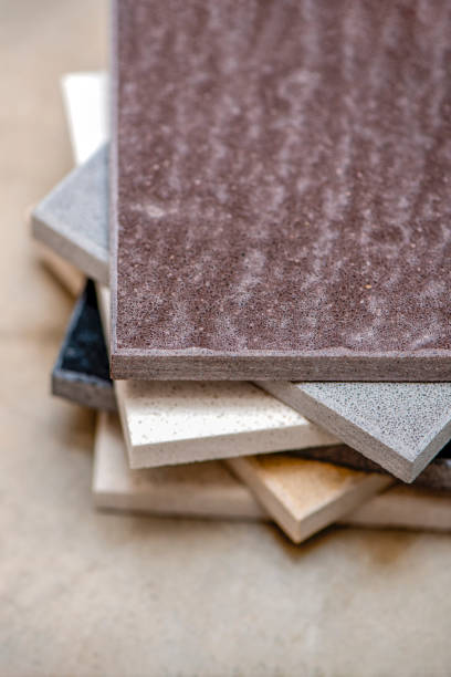 istock Samples of natural stone for kitchen countertops and floor tiles. Stone samples for countertops on gray background, copy space for design or text 1340743444