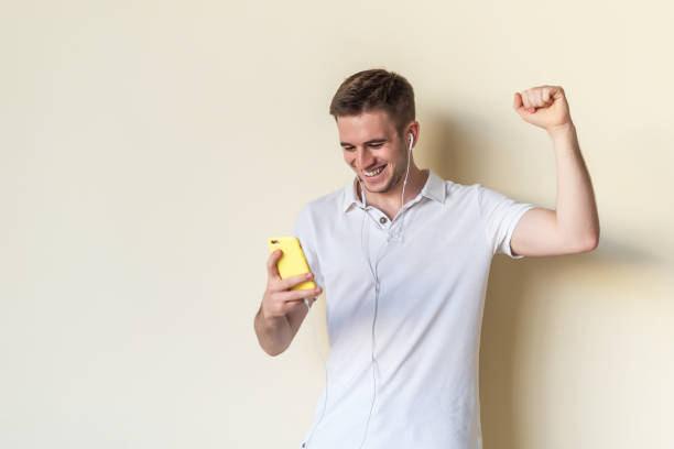 istock Young man happy with his smart phone 1340743714
