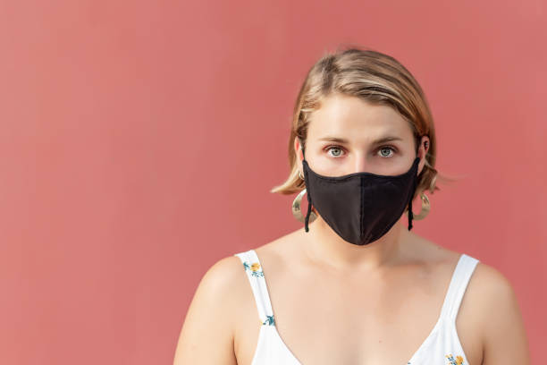 istock Young blonde woman with a black mask 1340743813