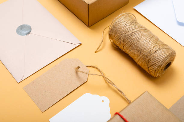 istock Composition of boxes, envelopes and gift tags on yellow background 1340745475