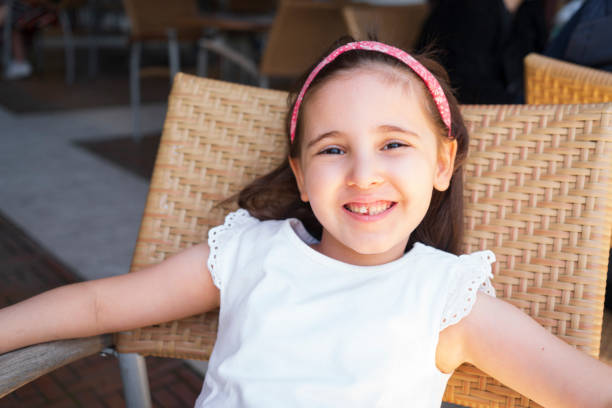 a smiling Asian girl playing in a park. portrait of Taiwan girl.