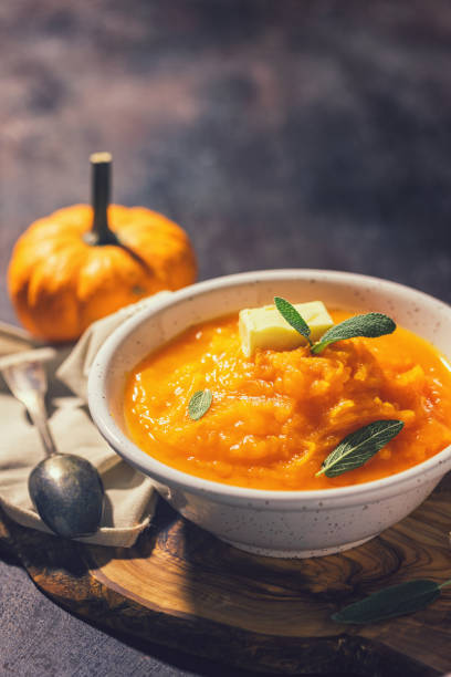 istock Homemade pumpkin cream soup with sage 1340750075