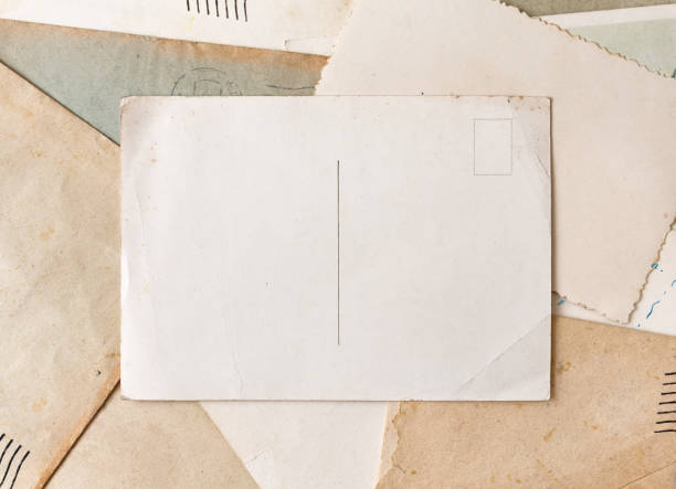 Vintage postcard on old grunge paper and envelopes background.