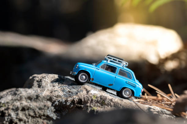 istock Cute little nonexistent retro car travelling in a woodlands 1340751813
