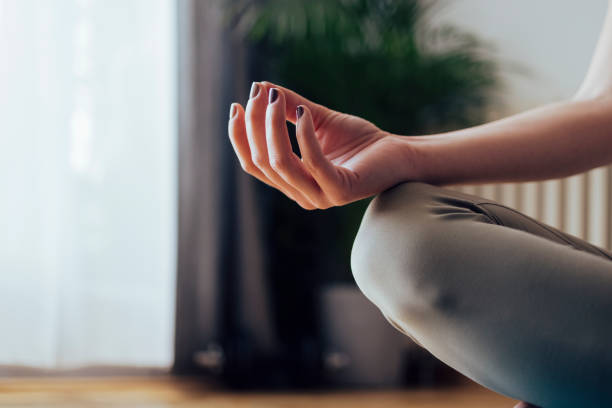 istock An Anonymous Woman Meditating at Home 1340753650