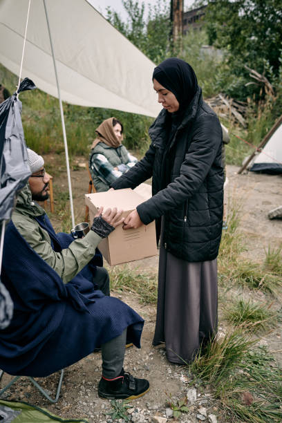 istock Sharing Stuffs With New Refugee In Camp 1340754949