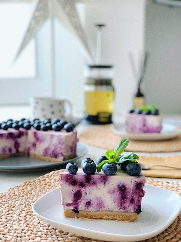Slice of blueberry cheesecake on a saucer
