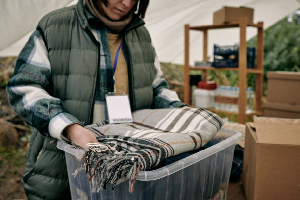 Volunteer Preparing Warm Blanket For Refugees