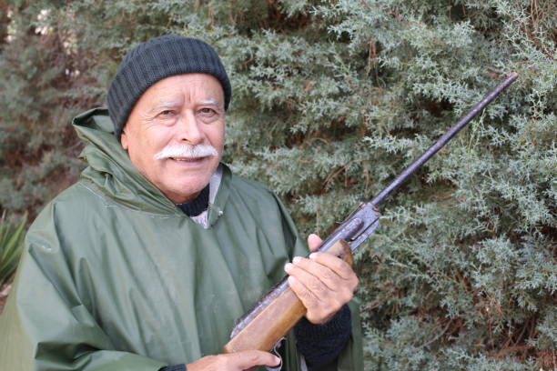 istock Senior hunter with a mustache in the forest 1340758932