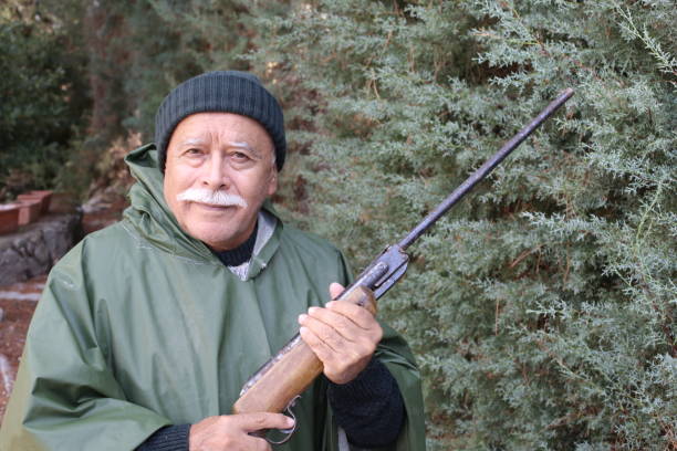 istock Senior hunter with a mustache in the forest 1340758938