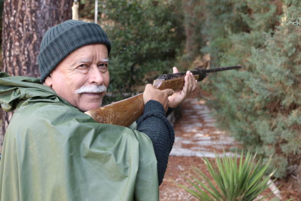 istock Senior hunter with a mustache in the forest 1340758946