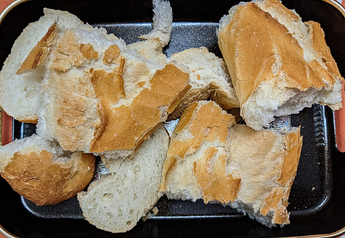fresh uneven structure of the pulp broken hands on a few pieces of a loaf of bread from flour of cereals, food items