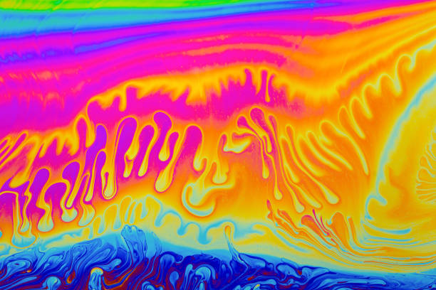 istock Rainbow colors. Psychedelic multi colored patterns background. Photo macro shot of soap bubbles 1340760269