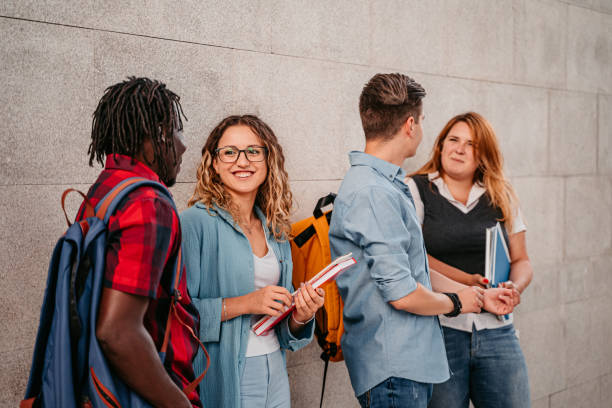istock Students discussing about class in lobby of university 1340760393