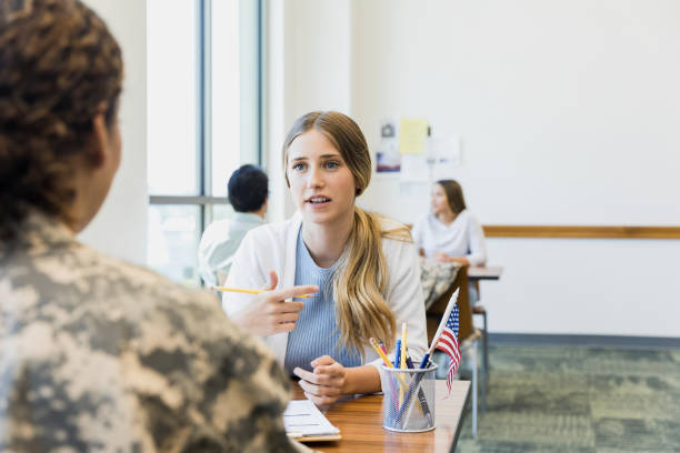 istock Female banker gestures while discussing financing options with unrecognizable soldier 1340760432