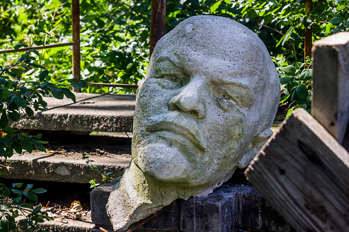 decommunization in Ukraine. Damaged bust of Lenin in the garbage dump