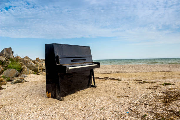 istock old piano on the sea beach 1340761712