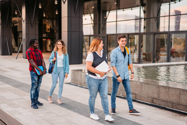 istock Friends walking in university campus 1340762619