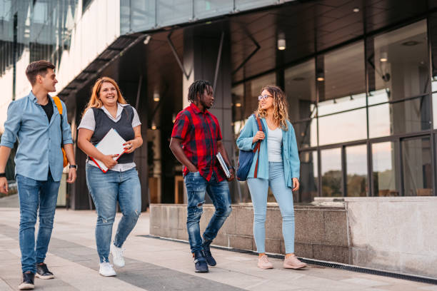 istock Friends walking in university campus 1340762705