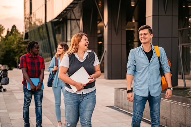istock Friends walking in university campus 1340763340