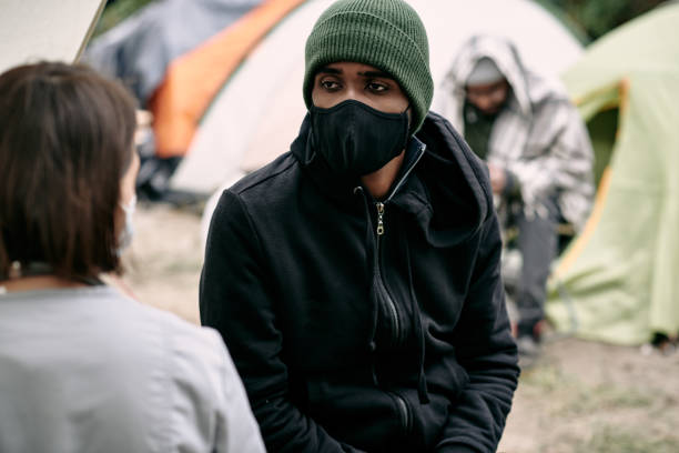 istock Black Refugee In Mask Talking To Nurse 1340765815