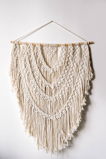 istock Handmade macrame hanging on white wall in bright room 1340765838