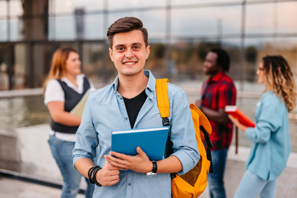 istock Handsome smiling male college student 1340766149