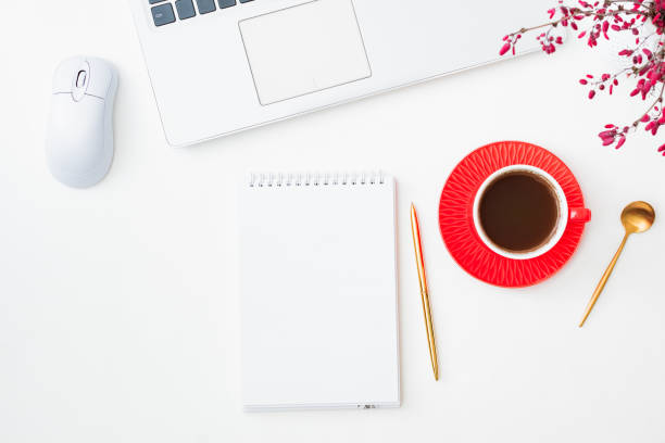 istock Mockup open white notepad with cup of coffee, branches with red berries, laptop on a white background 1340766194