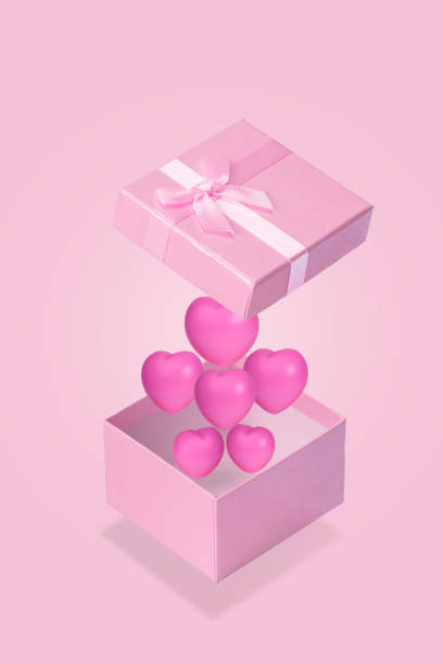 istock Hearts come out of a gift box on pastel pink background. 1340770229