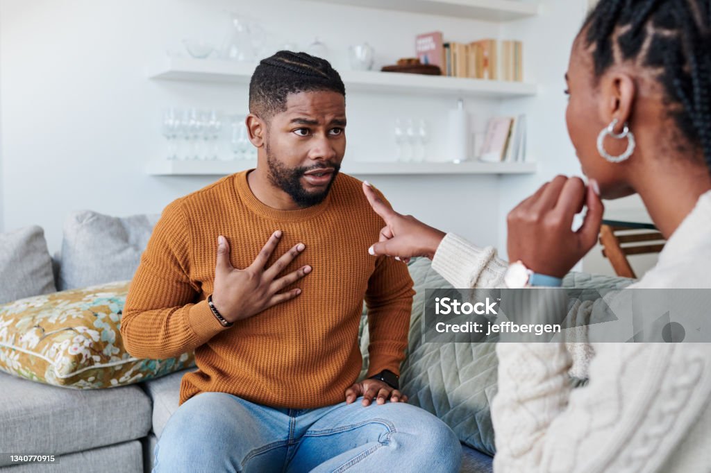Shot of a young couple having an argument at home You're to blame for all of this Arguing Stock Photo