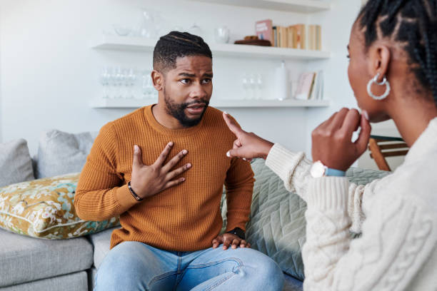 Shot of a young couple having an argument at home You're to blame for all of this man regret stock pictures, royalty-free photos & images