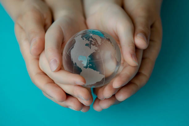 istock Mother And Her Daughter Are Holding A Glass Globe 1340771069
