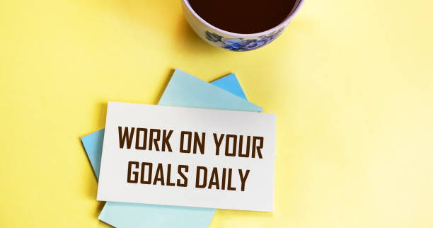 istock work on your goals daily - motivational reminder, coffee cup sticker handwriting, goal setting, business and personal development concept 1340773846