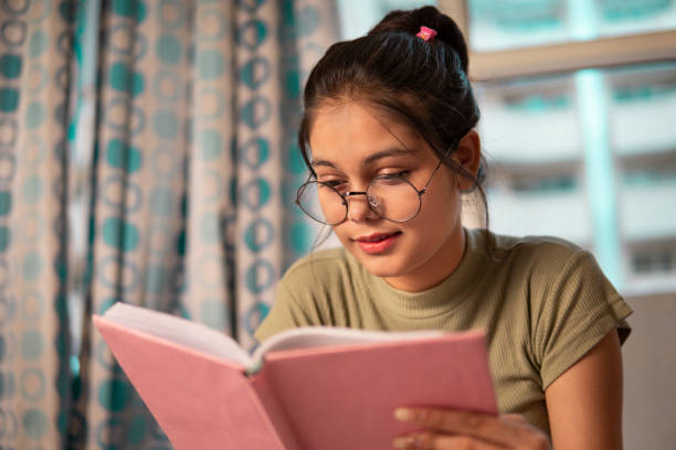 istock Young woman reading a book and doing preparation for the exam. 1340775939