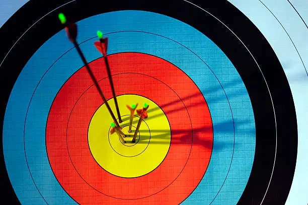 archery target hit by four arrows