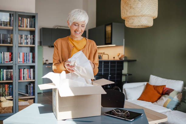 istock Senior woman unpack the package she ordered online 1340783972