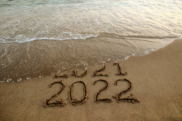 istock New year 2022 and 2021 on sandy beach with waves 1340784195