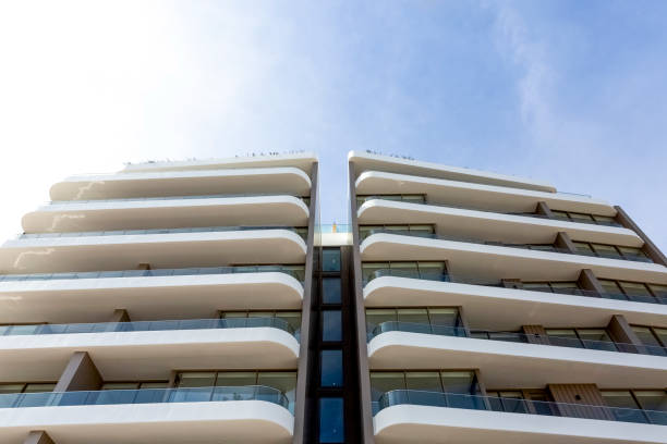 istock Low angle view of new, modern apartment building, sky background with copy space 1340789580